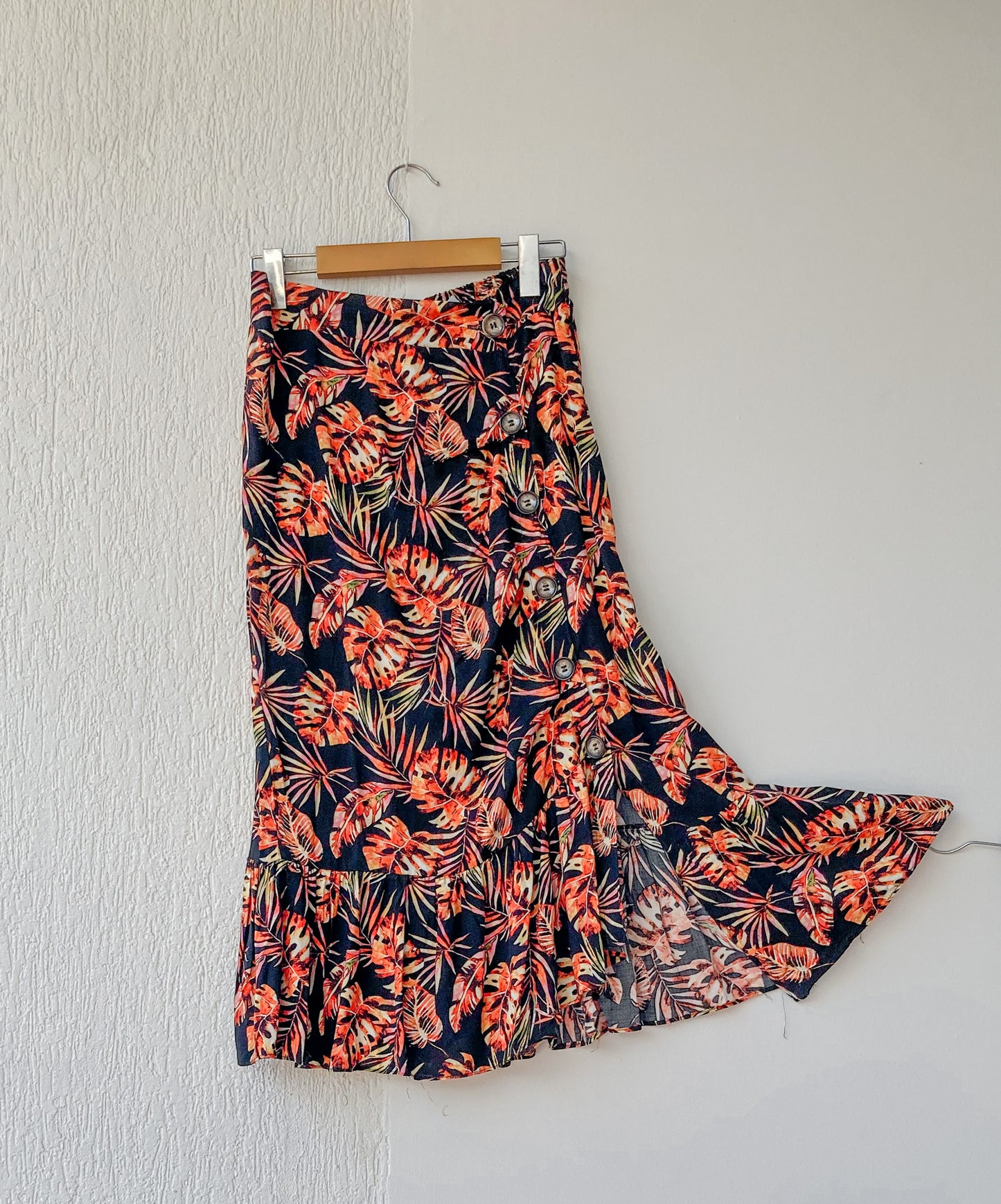 Falda midi desigual y con botones, y resorte posterior; 100% Colombiana. ESTAMPADO TROPICAL