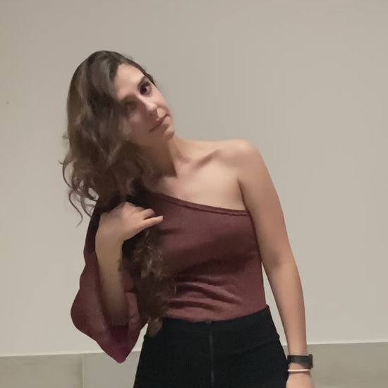 Este top asimétrico, para mujer, presenta un diseño de una manga con tres resortes, además de una textura brillante que la hace única. Es ideal para cuando quieres destacar. ¡Da tu look un toque moderno con Gaia!   100% Colombiana, producto local.
